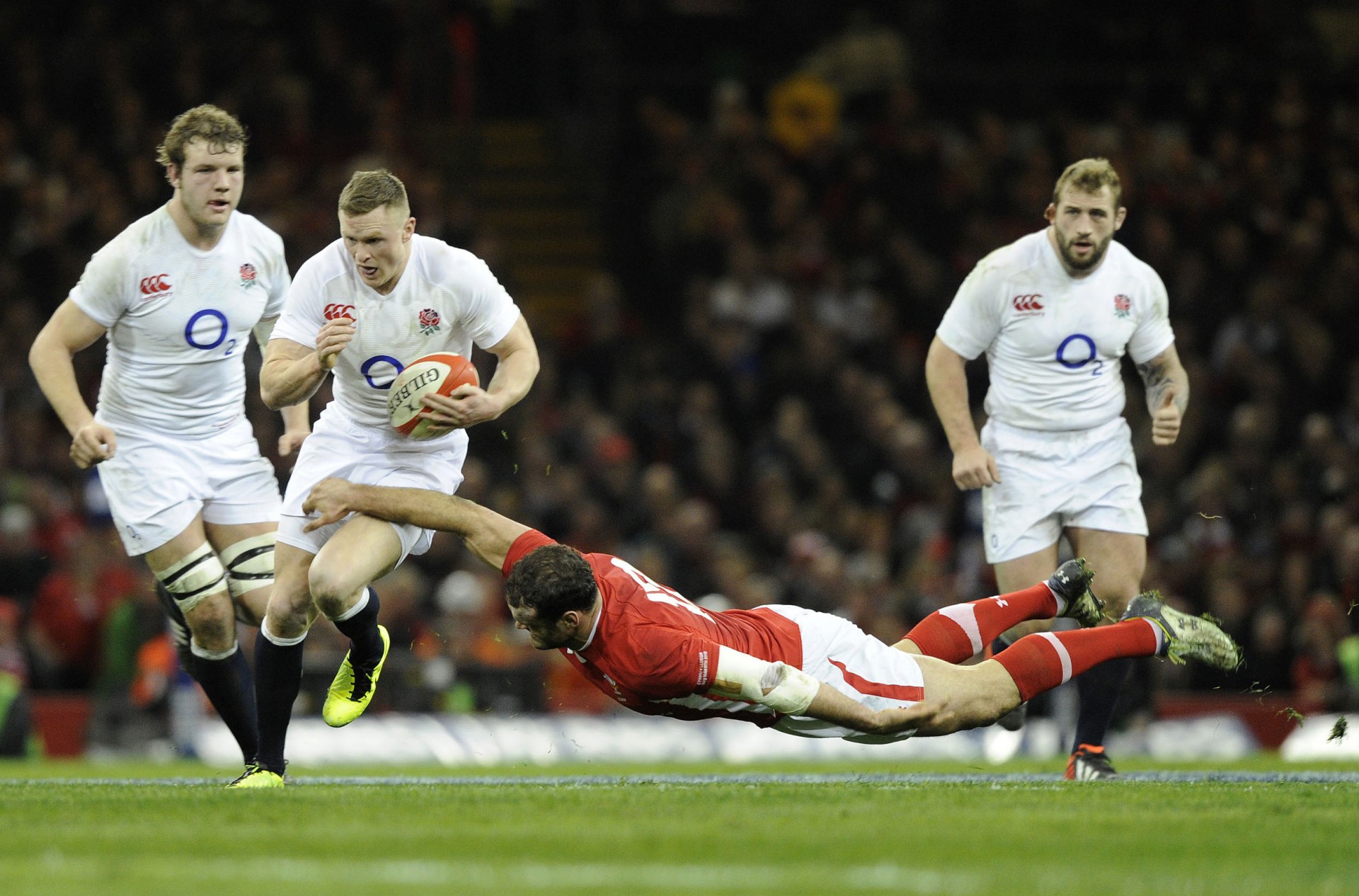 England's Ashton is tackled Wales' Roberts during their Six Nations international rugby union match at the Millennium Stadium in Cardiff